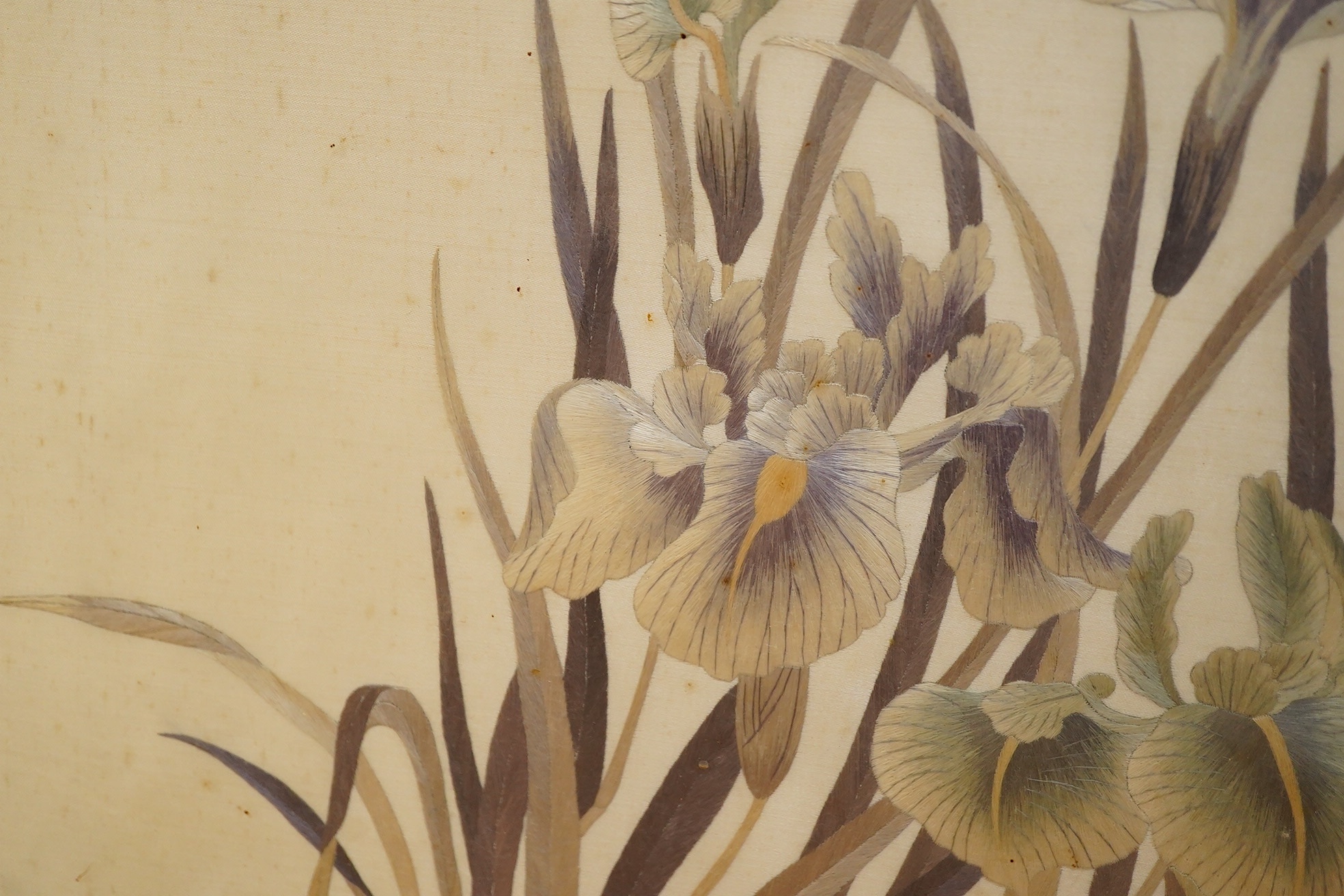 Two early 20th century Japanese cream silk polychromes embroidered panels of flowers birds and butterflies, largest 45cm wide x 37cm high. Condition - there are marks on the cream silk, which may be able to be profession